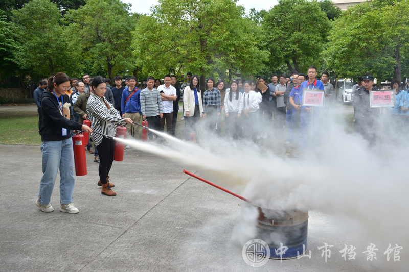 图4：市档案信息中心人员进行灭火实操（摄影：蓝子键）.jpg